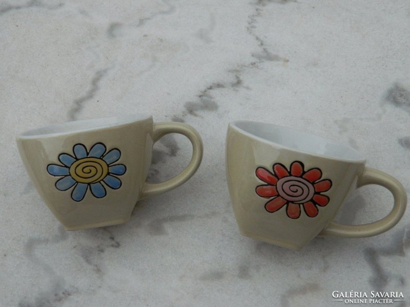 A pair of lovely thick village coffee cups with a flower pattern