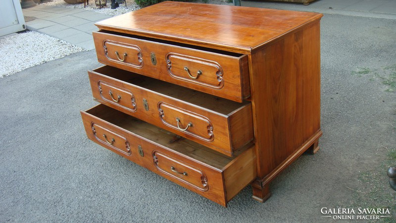 Punctured baroque cherry wood chest of drawers.