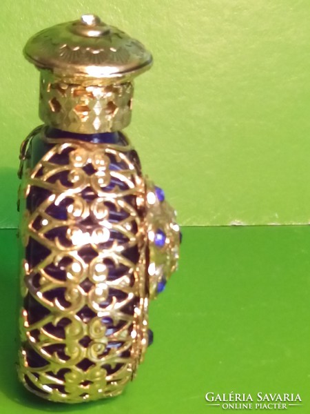 Antique perfume cologne bottle with copper decoration