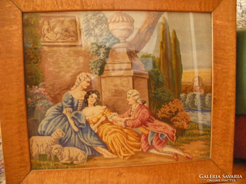 Antique needle tapestry in a beautiful frame behind glass