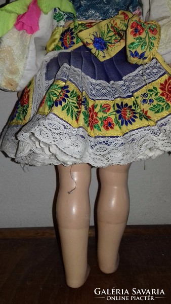 Antique old doll in hand-embroidered folk costume