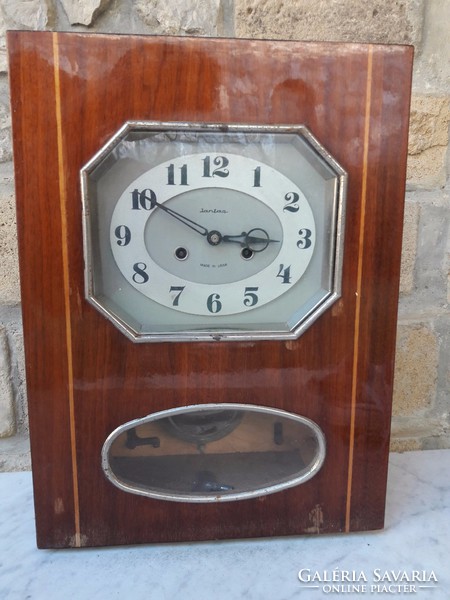 An elegant wall clock with a rare form of old amber