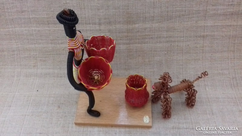 A bent negro female figure with a basket and a dog, handmade from retro marked wire