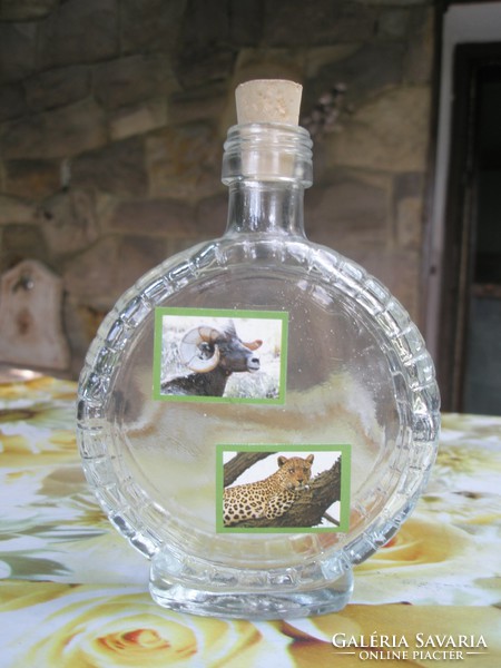 Glass bottle with bottle of brandy with animal motifs