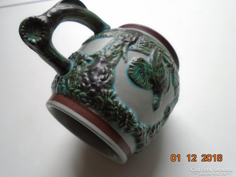 Decorative hunter's cup with raised tree, flower and animal patterns with green tones