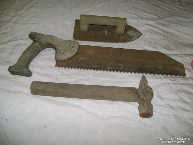 Old tools - saw, hammer, trowel - all three together
