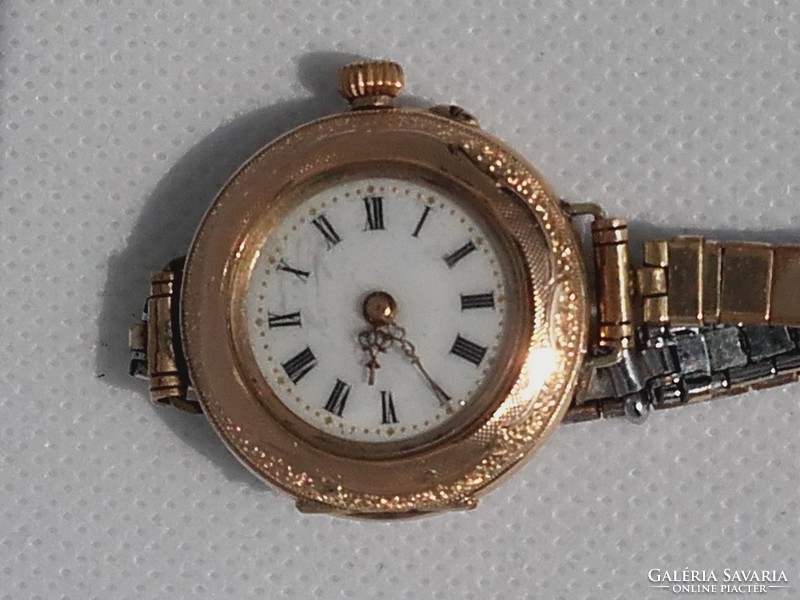 Gold watch is 14 carats, 31 grams.