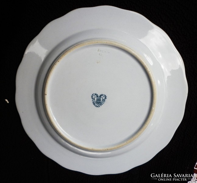 A pair of Zsolnay plates with a heart seal and monogram