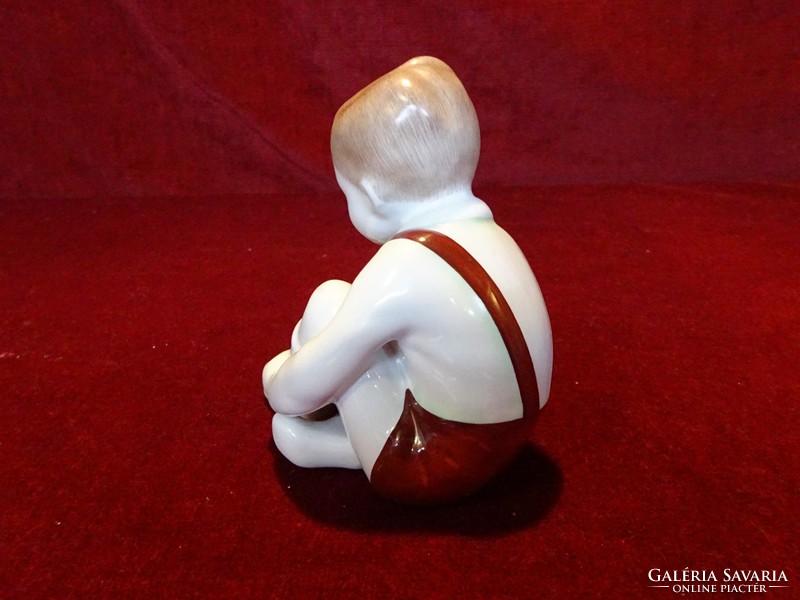 Aquincum porcelain figural statue, little boy tying shoes. 11 cm high, 10 cm wide. He has!