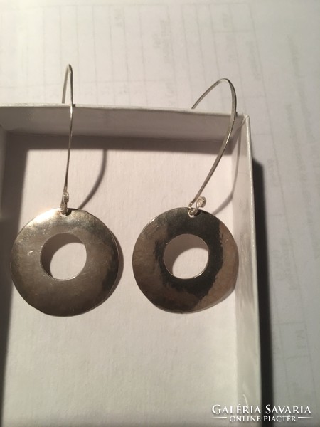 Silver hoop earrings on a larger hanger
