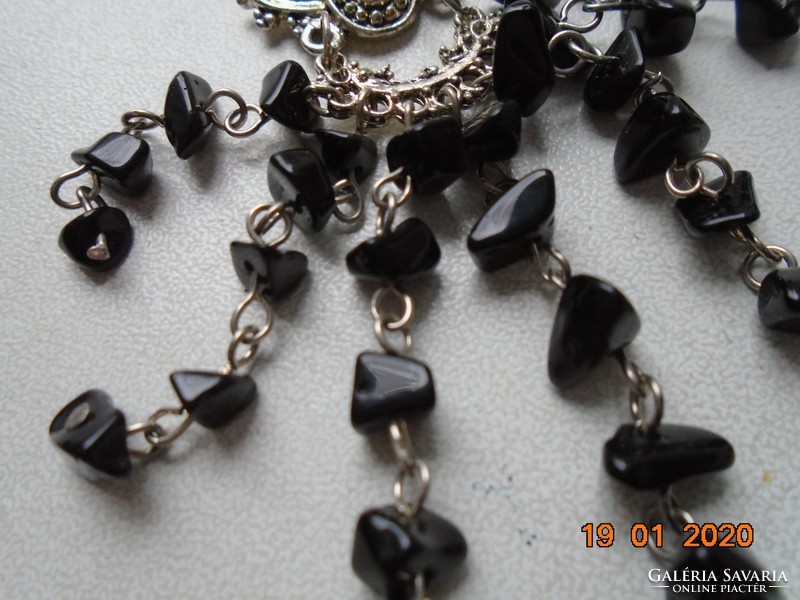 Black mineral with small stones on chain links chandelier earrings on ornate enamel frame
