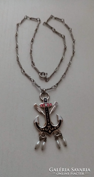 Fire enamel anchor-shaped pendant on a chain with twisted links