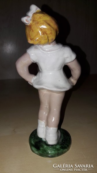 Old ceramic little girl figurine in white dress with nipple