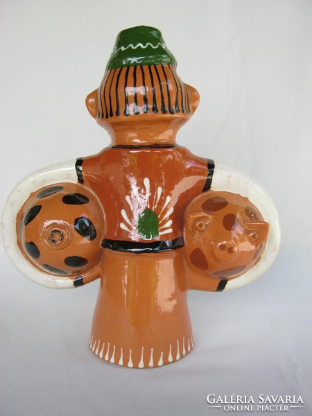 There is a pig... Glazed earthenware ceramic male figure with two little pigs 25 cm