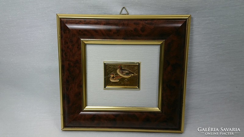 A small picture of a wild duck covered with gold foil, from around the middle of the 20th century.​