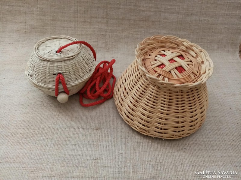 Old lace tablecloth with crochet hooks in a log with a ball in a small wicker basket with supplies