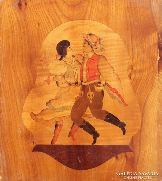 Old, colorful intarsia decoration: self-absorbed dancers