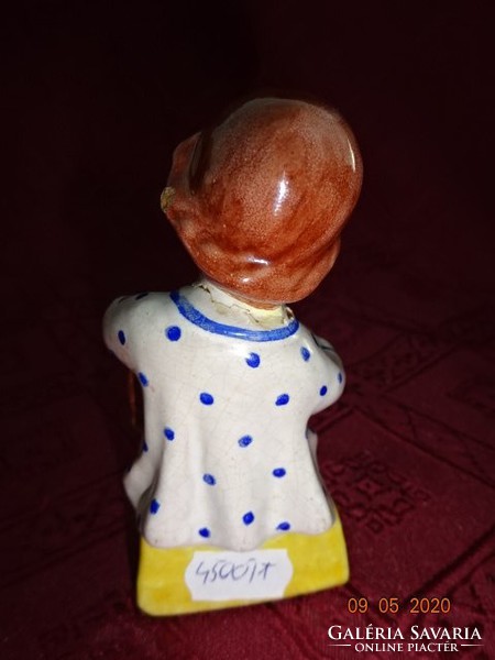 Glazed ceramic figure, girl taking off her shoes, height 10 cm. He has!