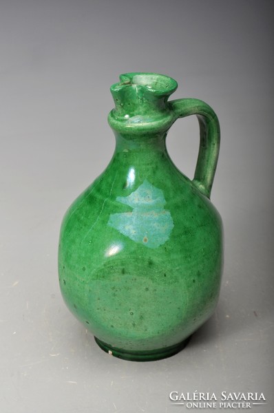 Small jar with green glaze, flattened on four sides.