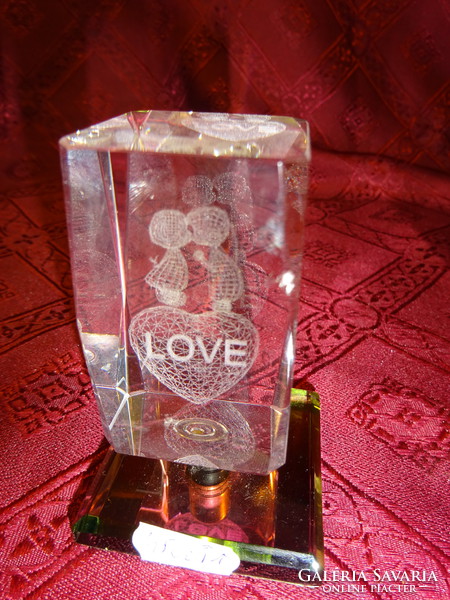 3D laser engraved glass block with the word love. Its height is 8 cm. He has!
