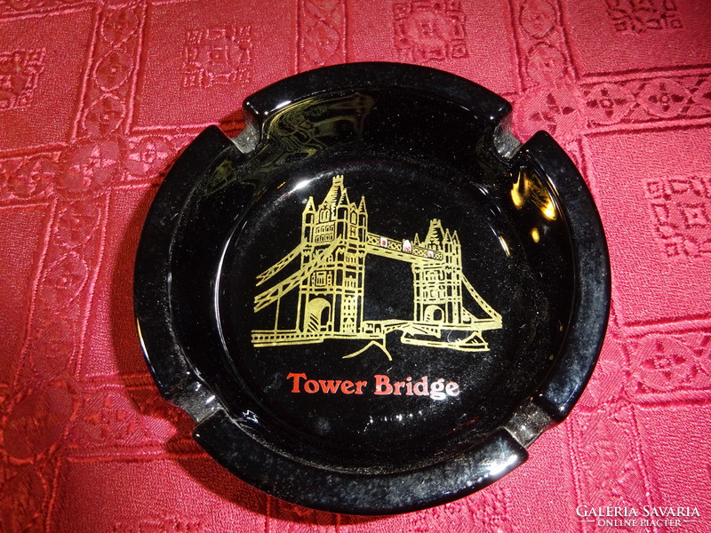 Black glass ashtray with tower bridge skyline and London inscription. He has!
