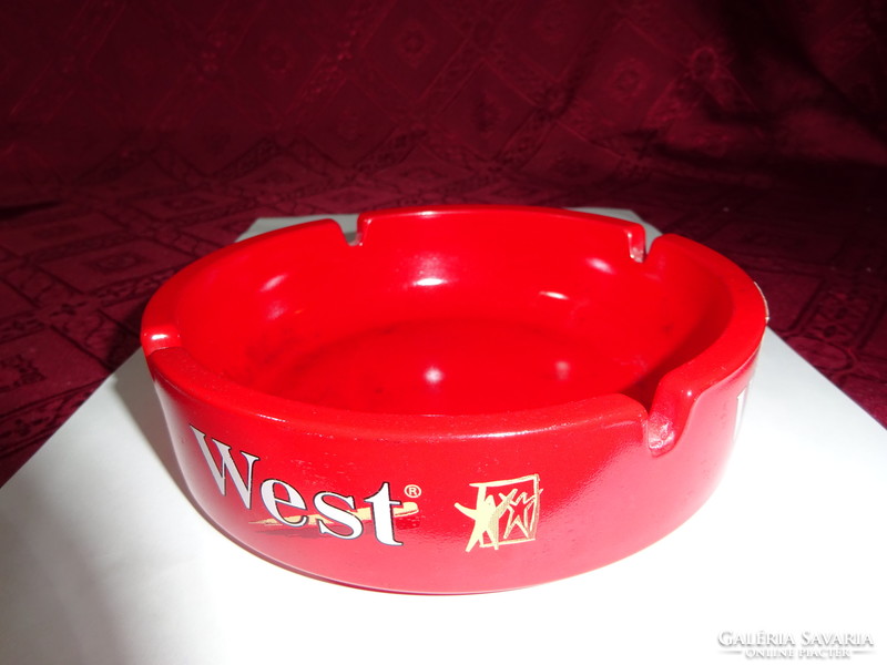 Red glass ashtray, diameter 14.5 cm. Inscribed West. He has!