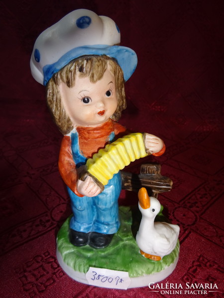 Porcelain figurine, accordion boy with goose, height 14.5 cm. He has!