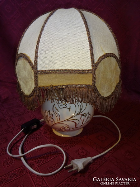 Spanish porcelain bedside lamp with linen and fringed lamp. He has!