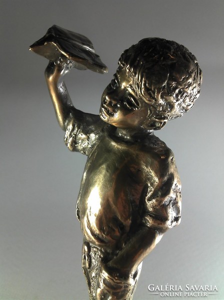 Bronze statue of little boy flying