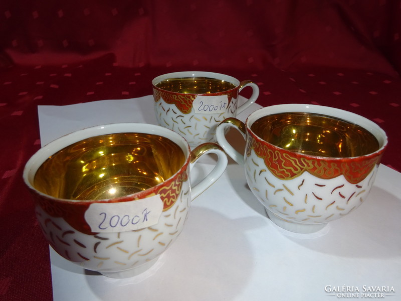 German porcelain coffee cup, gold inside, gold cirada on the outside. He has!