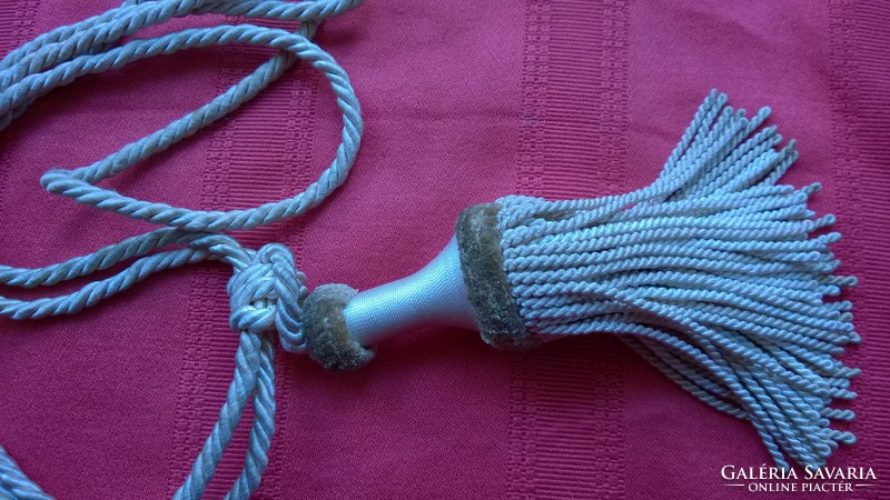 Silver colored curtain tassel with cord