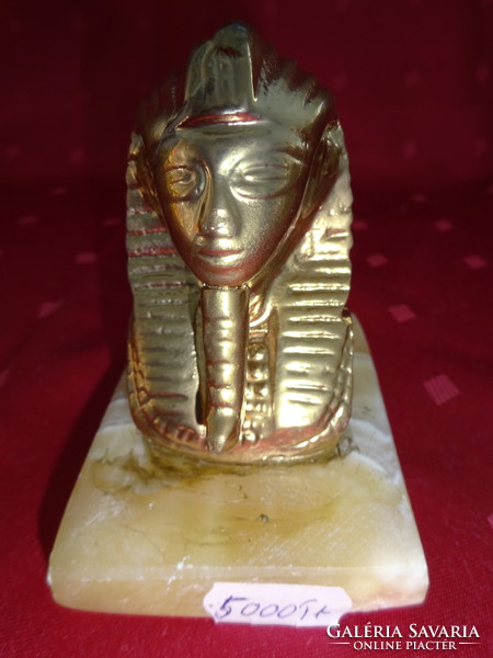 Bust of Pharaoh Tutankhamun on a marble background. He has!