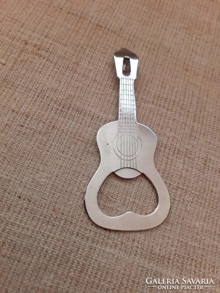 A guitar-shaped beer opener has a can opener at the end