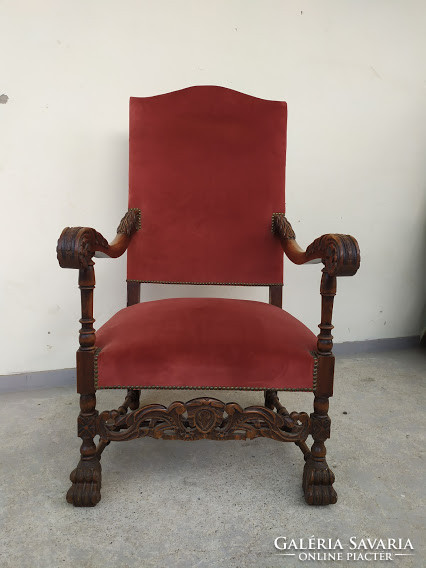Antique richly carved renaissance chair with throne