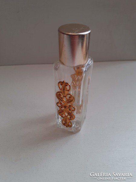 A white perfume bottle with a pattern, decorated with a gilded patterned plate on both sides, in good condition