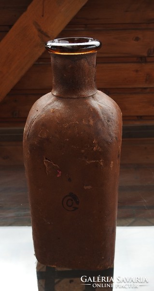 Old leather covered glass bottle