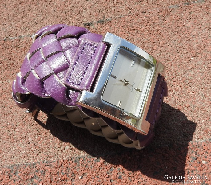 Interesting large dial quartz watch with a purple leather strap
