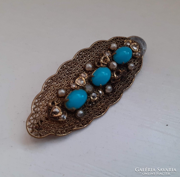 Old openwork pattern brooch adorned with blue stones