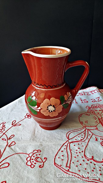 Old, hand-painted, ceramic jug, pitcher from a muddy stream.
