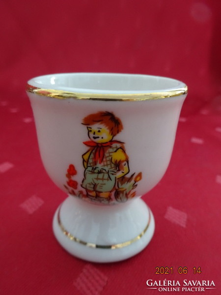 German porcelain egg cup, little boy on the side with gilded border. He has!