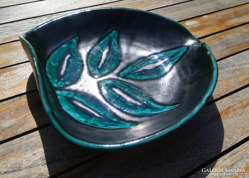Ceramic ashtray and bowl with green leaves on a black, somewhat iridescent background, in a special shape of retro industrial art