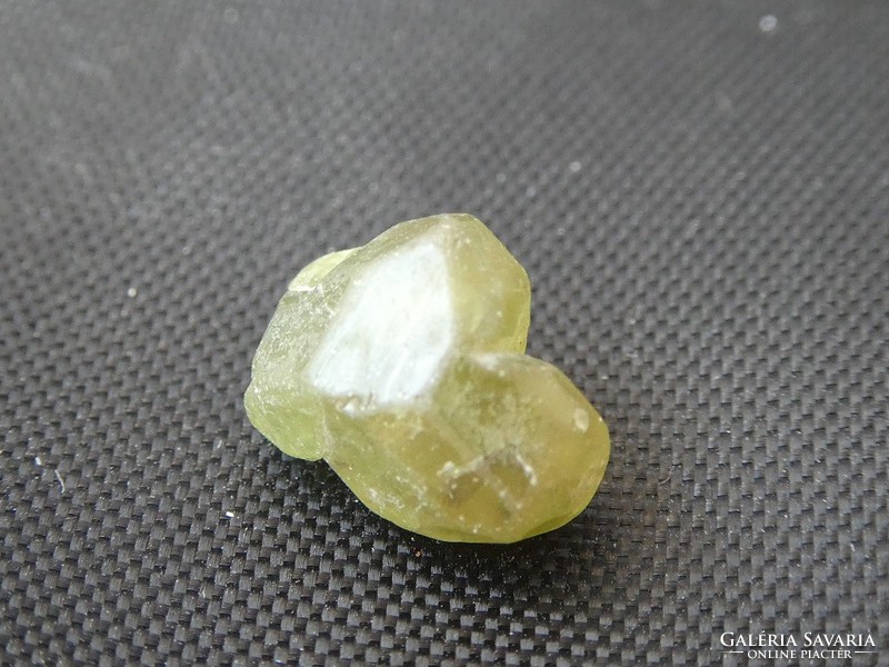 A piece of natural demantoid garnet. Raw mineral. Jewelry base material. 3.4 Ct
