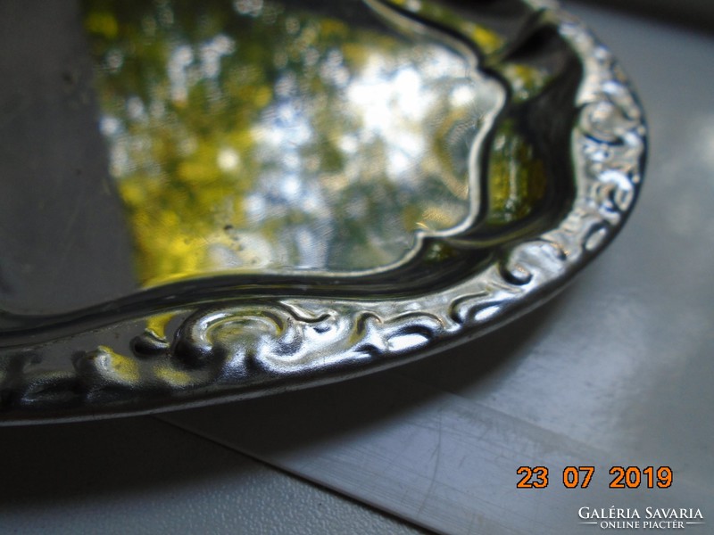 Chromed metal tray with an oval convex rim pattern