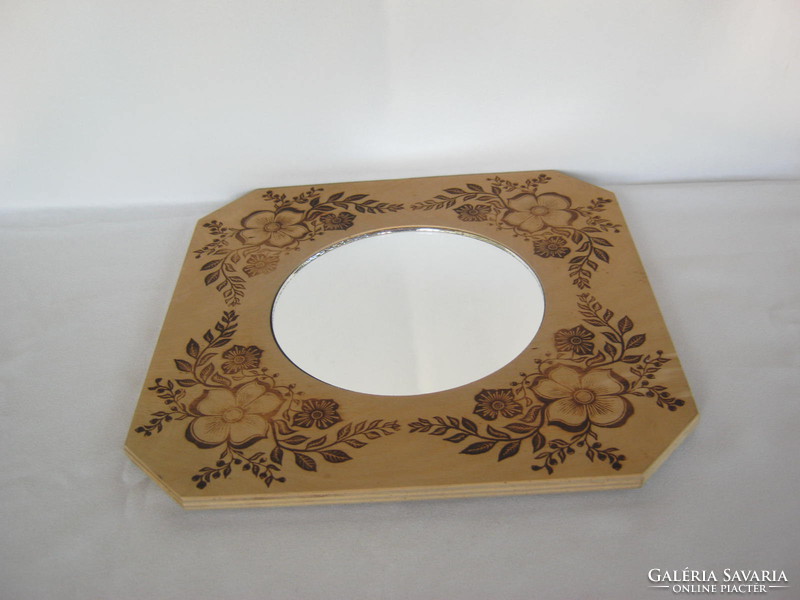 Retro wall mirror with wooden frame decorated with flowers