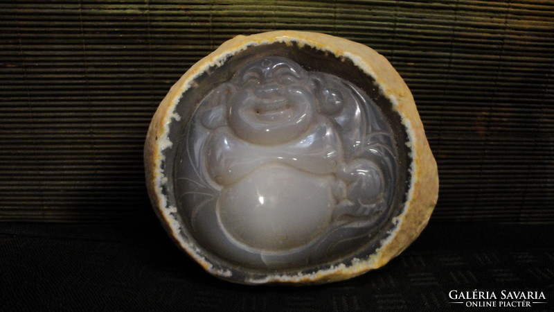 It contains opal stone, closed geode, water with Buddha carving