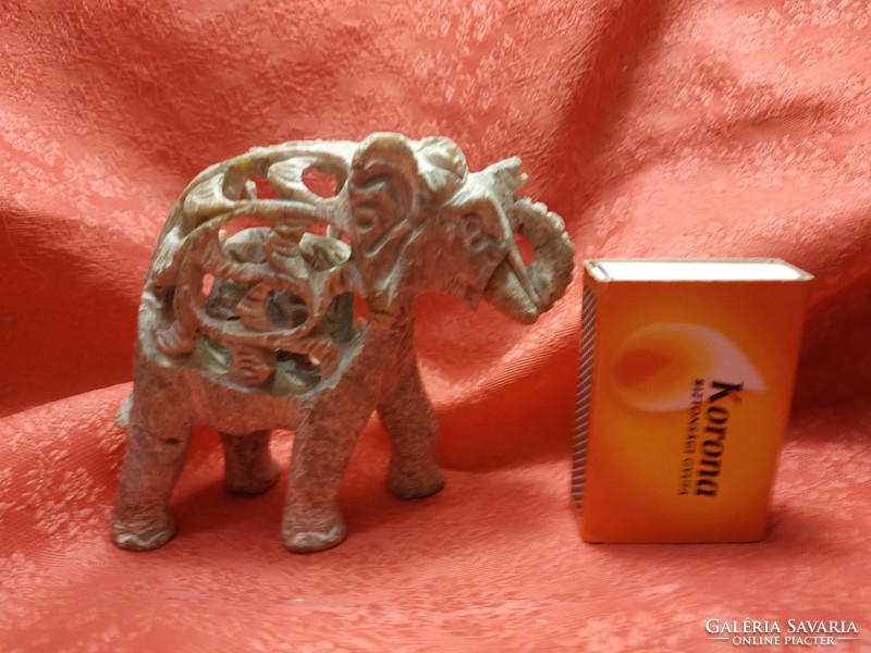 Small Indian elephant in its big belly, stone statue