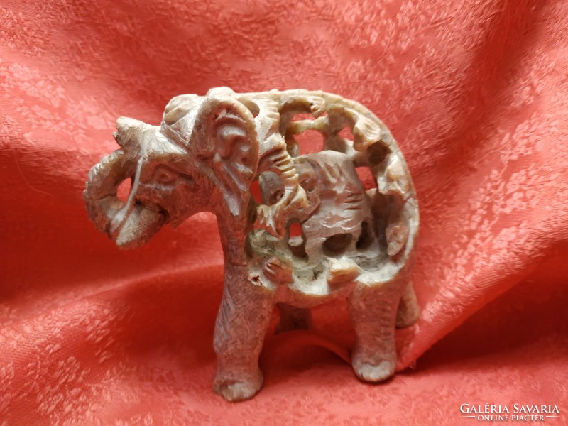 Small Indian elephant in its big belly, stone statue