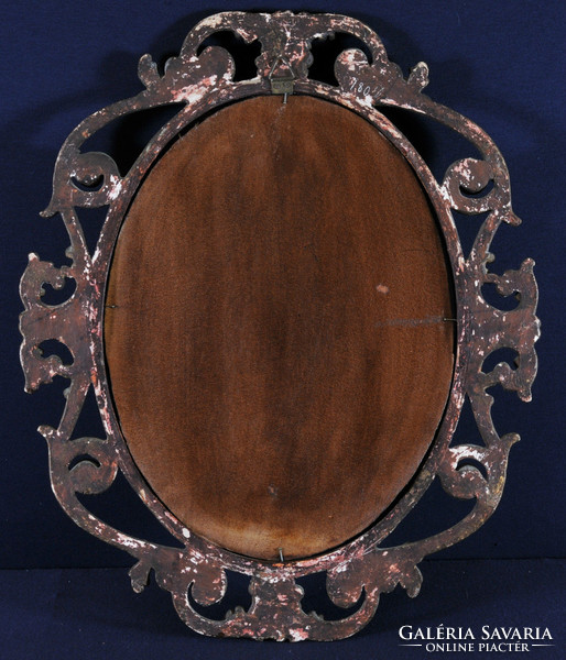 Antique carved gilded frame with oval mirror
