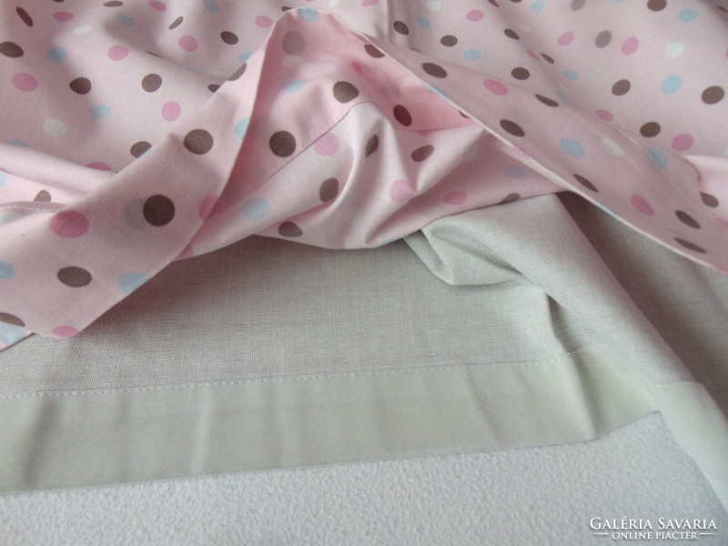 Lined curtains in pairs on a pink background with polka dots