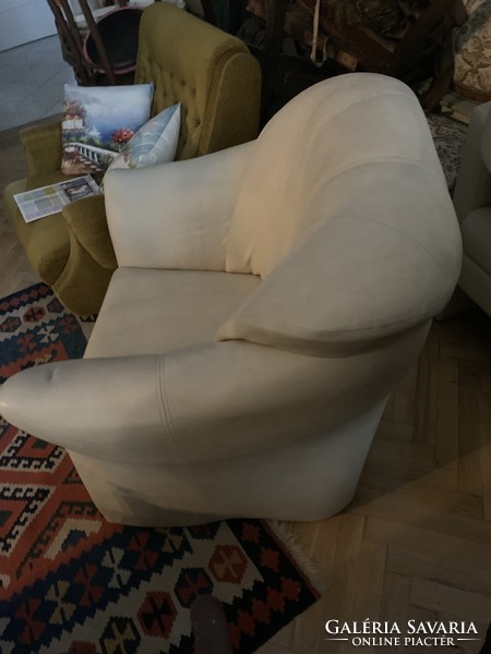 Beige (sometimes pale blue) leather armchair